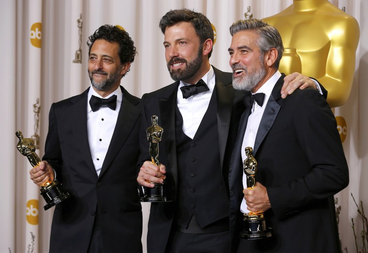 Image: The producers of \"Argo pose with their awards backstage at the 85th Academy Awards in Hollywood